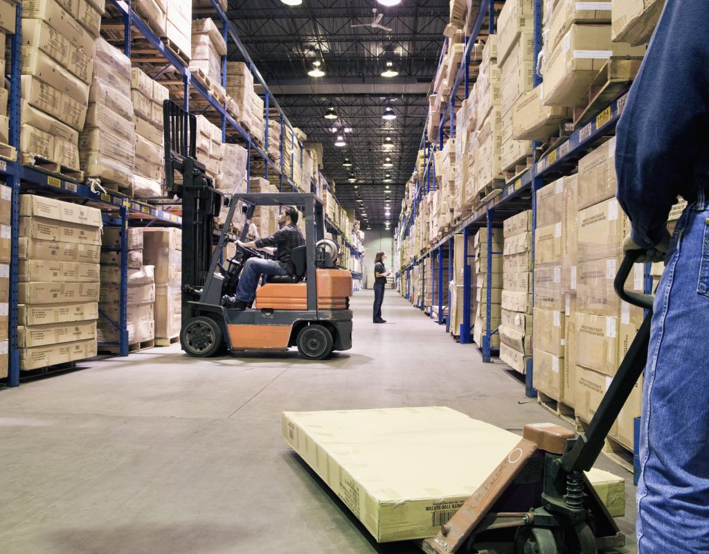 Staffs working different tasks in a warehouse Staffs working different tasks in a warehouse